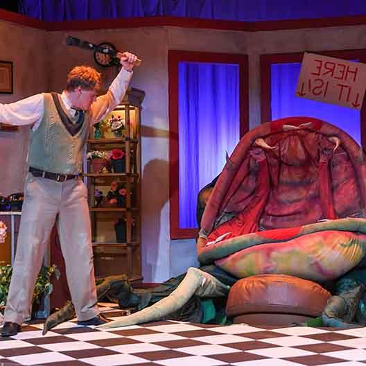 A student performs in Little Shop of Horrors